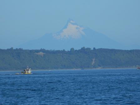 A boat on water with a snow-capped mountain in background