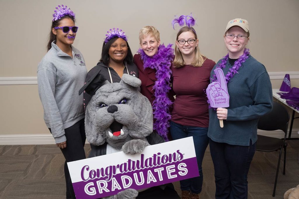 President Thomas and graduating students at the senior pizza party