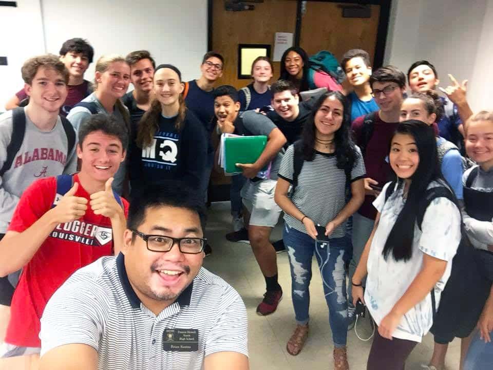 Teacher taking selfie with students